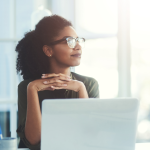 woman thoughtfully looks out the window